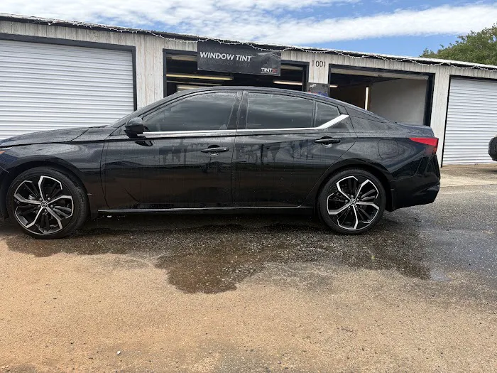 Black sedan with tinted windows outside DB Window Tint at 1001 Wiles Road