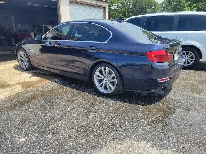 Blue BMW sedan parked beside the DB shop